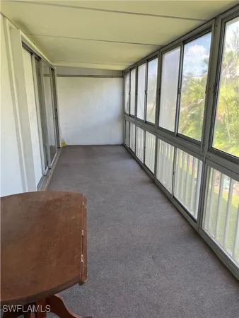 a view of an empty room with windows