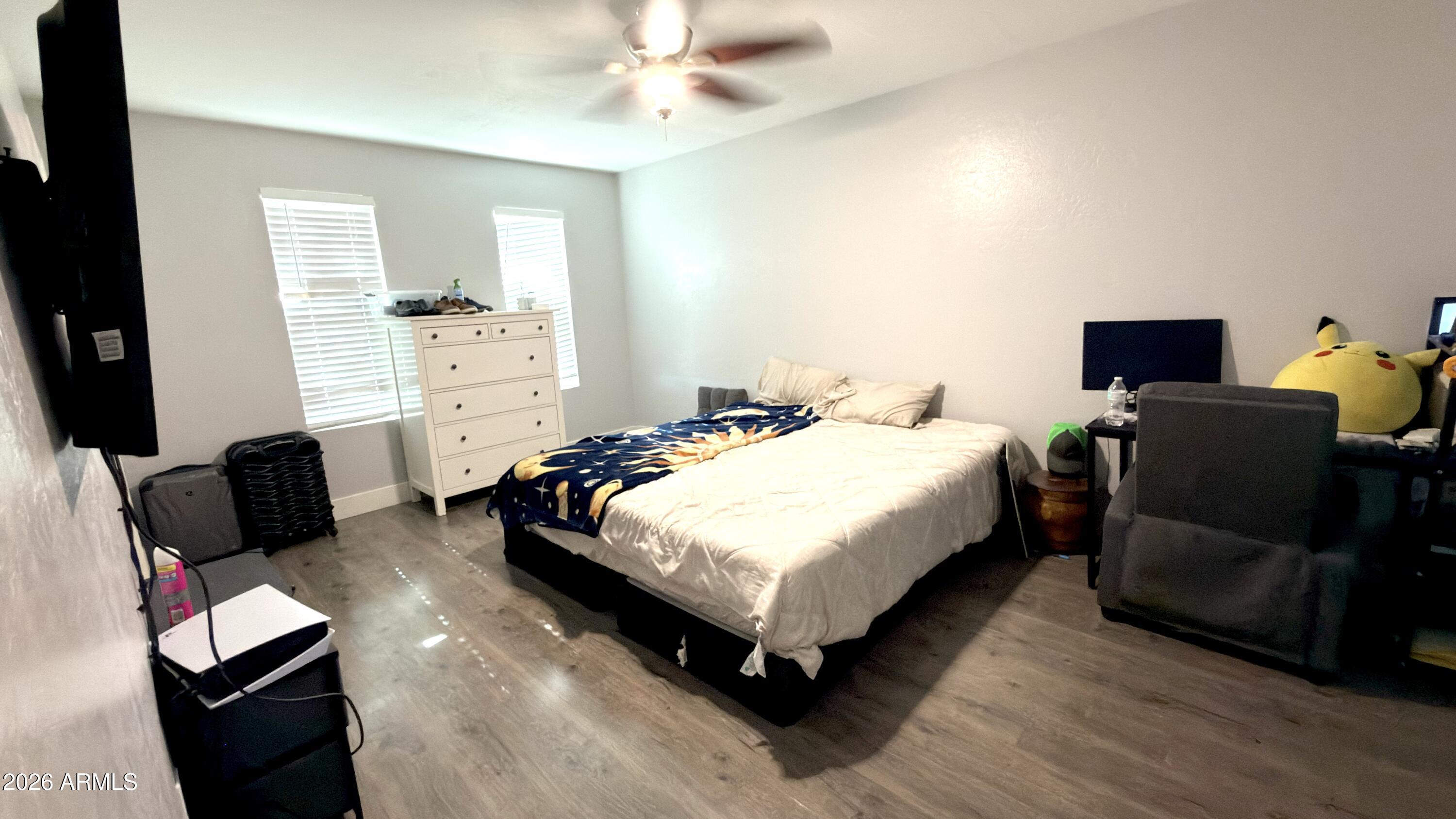 480 West Harrison Street Chandler, AZ 85225 - Photo 13 of 28 a bedroom with a bed and wooden floor
