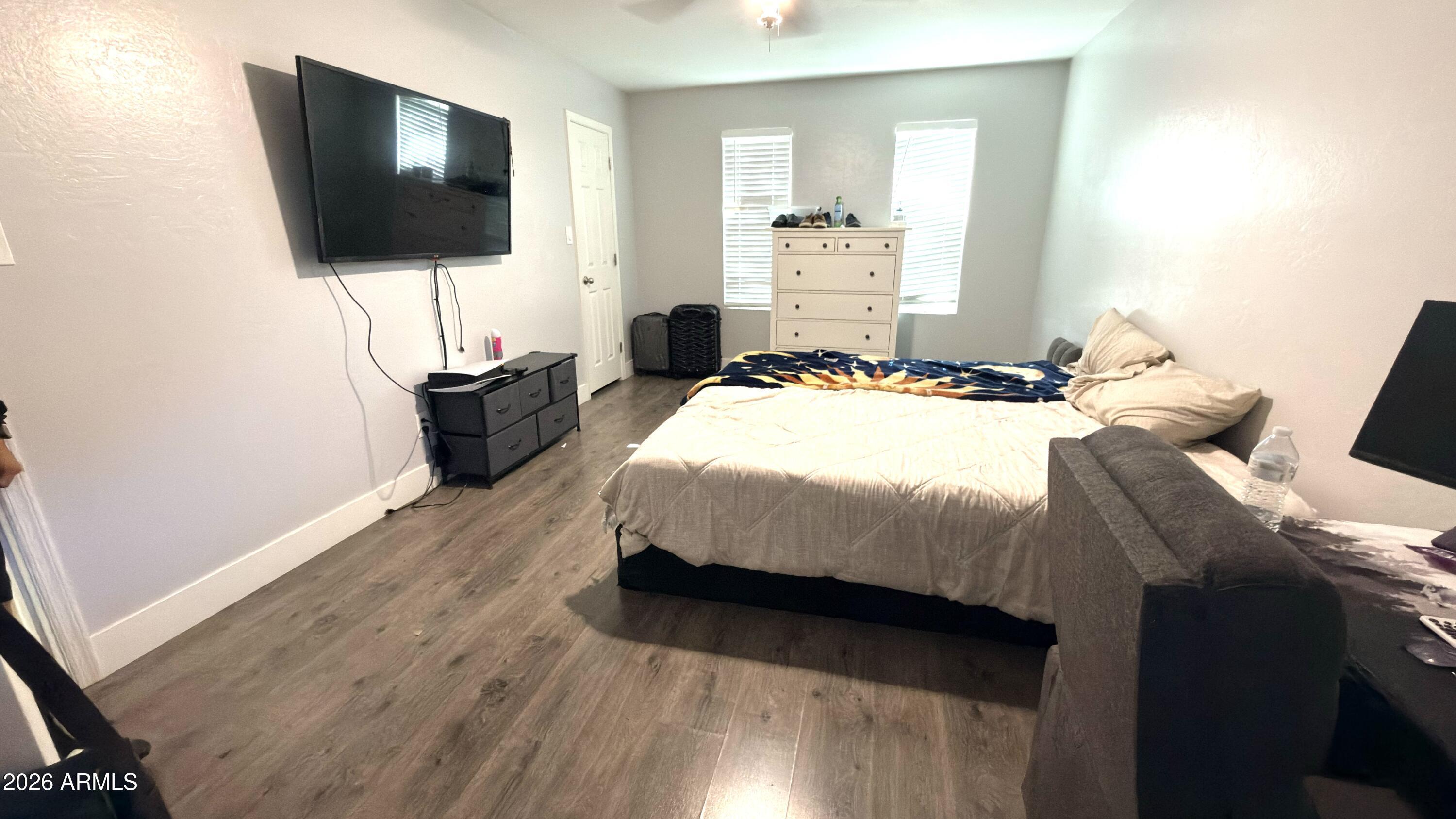 480 West Harrison Street Chandler, AZ 85225 - Photo 14 of 28 a bedroom with a bed and flat screen tv