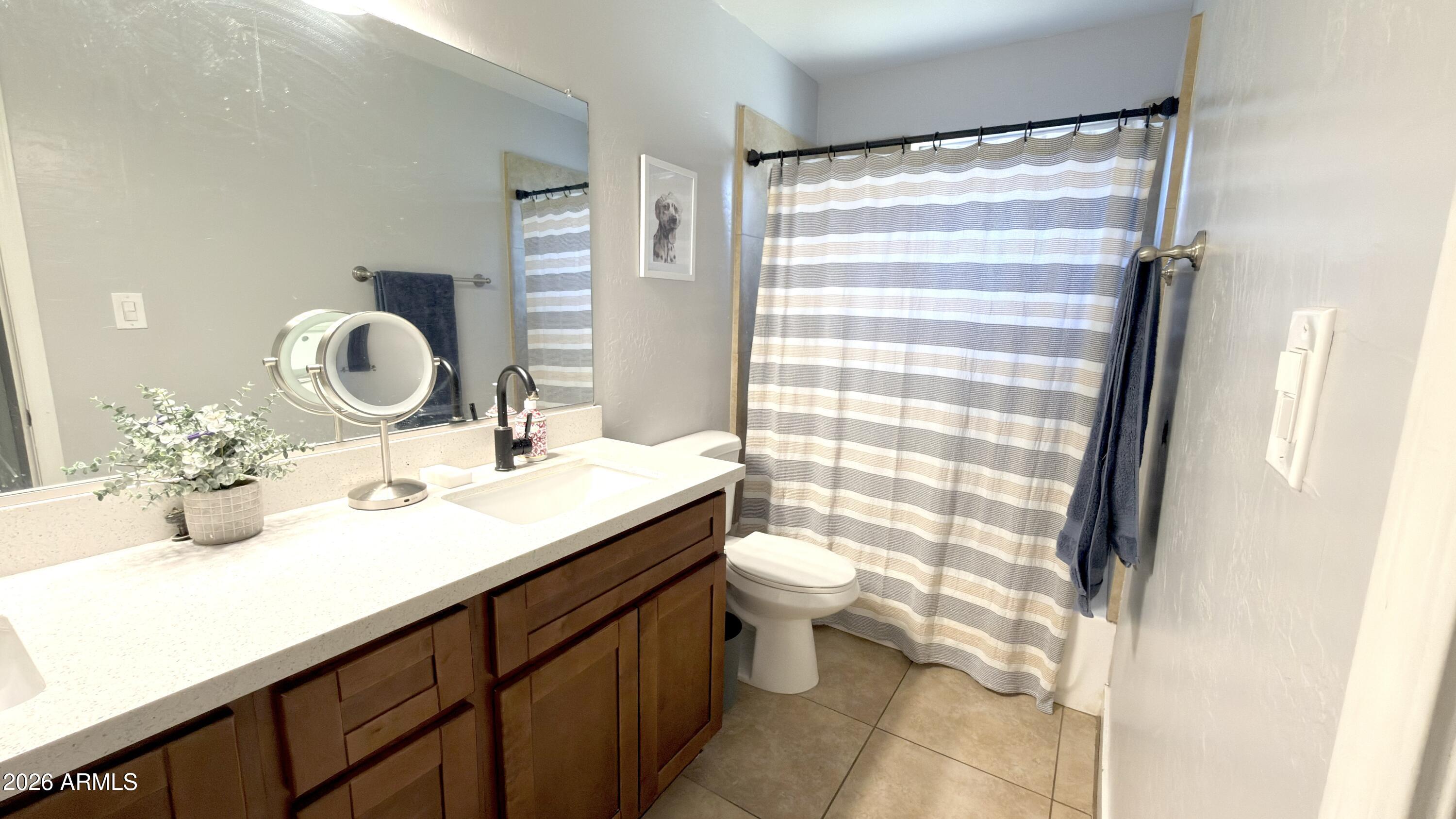 480 West Harrison Street Chandler, AZ 85225 - Photo 18 of 28 a bathroom with a granite countertop sink mirror vanity and toilet