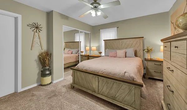 a bedroom with a large bed and a chandelier