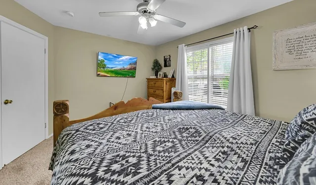 a bedroom with a large bed and a window