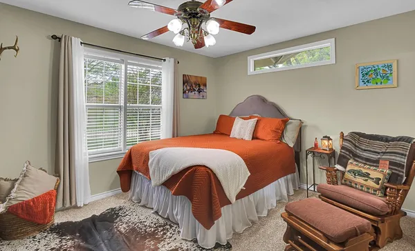 a backyard of a house with large trees and barbeque oven