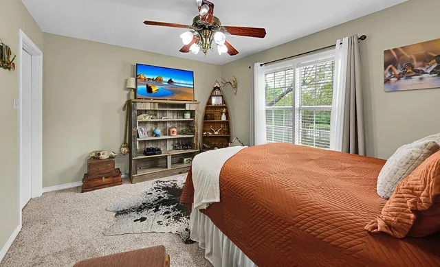 a view of a yard with a fence and trees