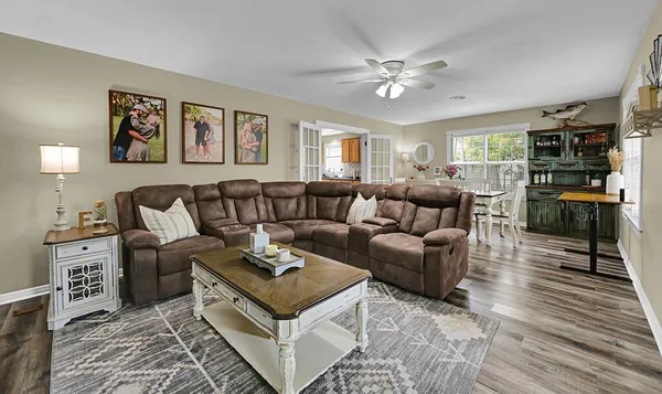 a living room with furniture and wooden floor