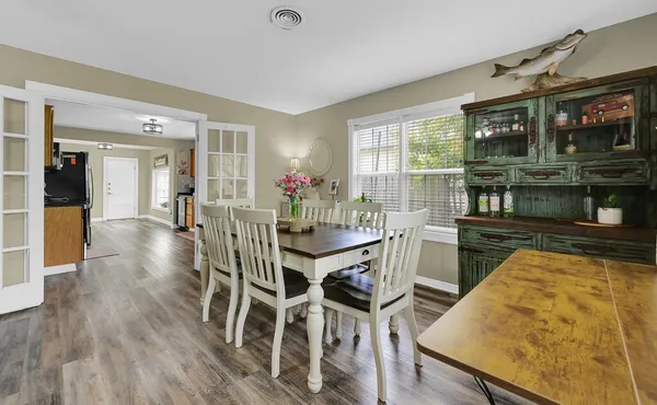 a view of a dining room with furniture and wooden floor