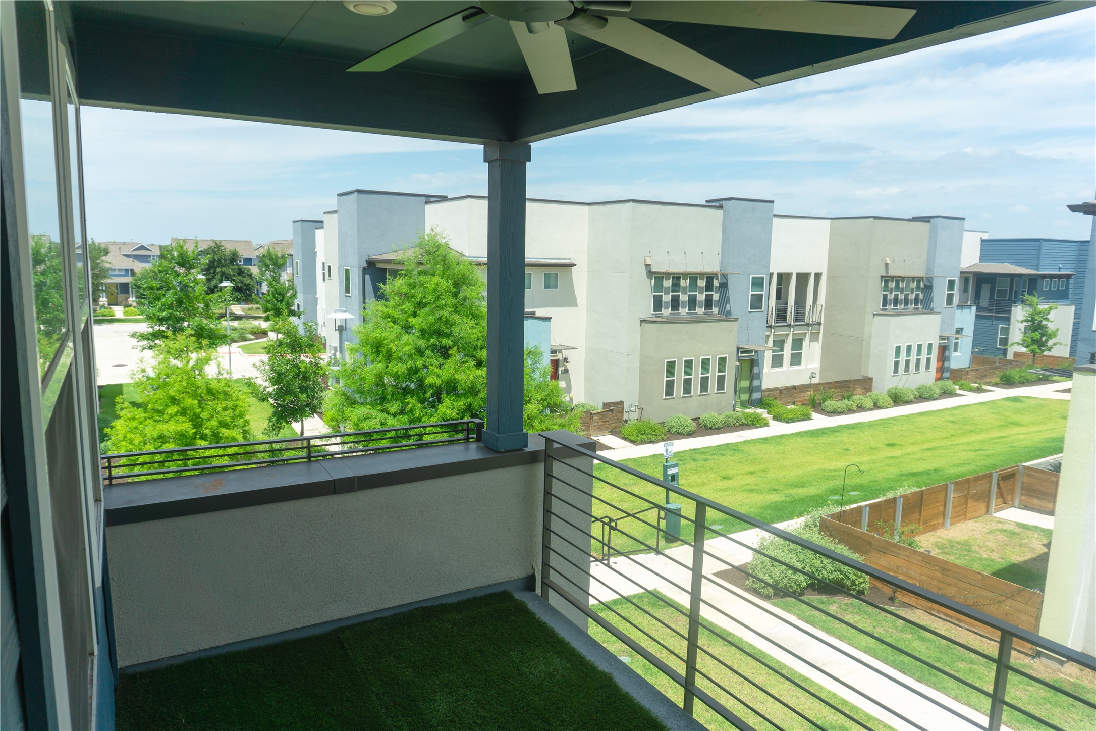 9015 Cattle Baron Path, Unit 605 Austin, TX 78747 - Photo 12 of 20 Turfed balcony with a ceiling fan.
