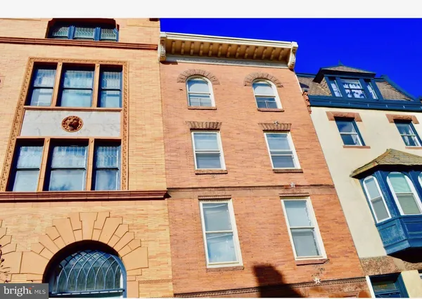 a view of a brick building with large windows
