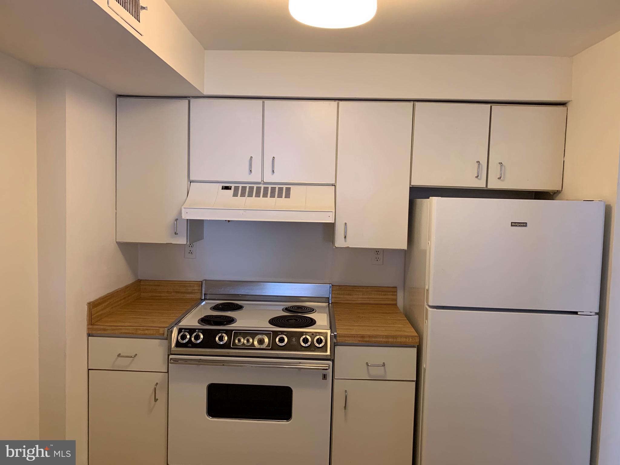 1207 Locust Street, Unit 2F Philadelphia, PA 19107 - Photo 2 of 19 a kitchen with a stove and a refrigerator
