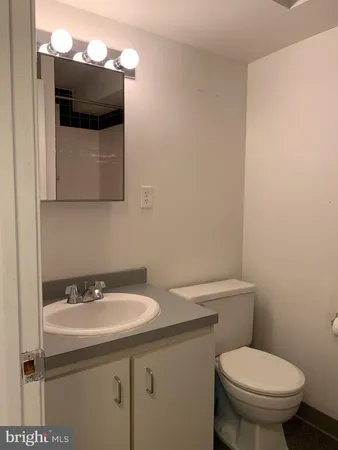 a bathroom with a sink toilet and mirror