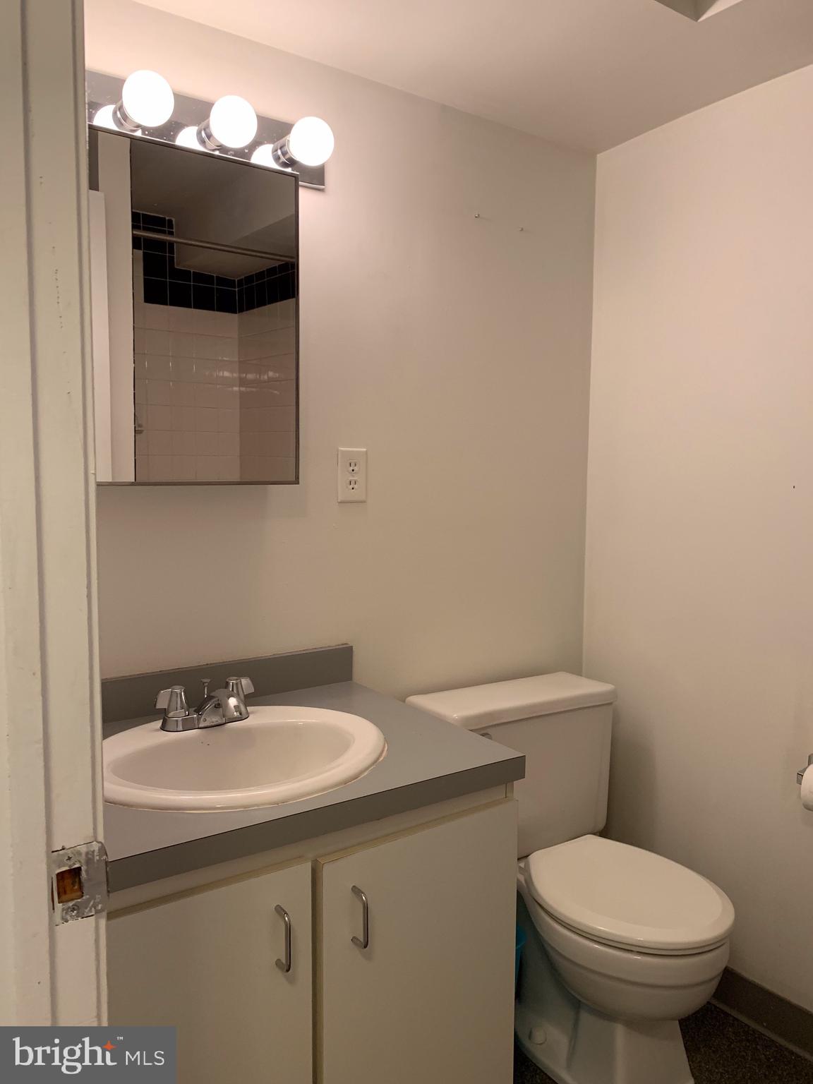 1207 Locust Street, Unit 2F Philadelphia, PA 19107 - Photo 5 of 19 a bathroom with a sink toilet and mirror