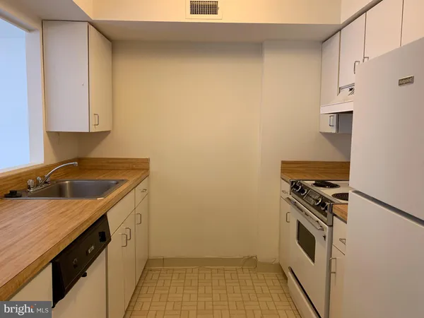 a kitchen with a sink stove and microwave