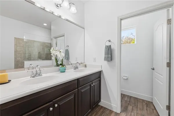 a bathroom with a double vanity sink and a mirror