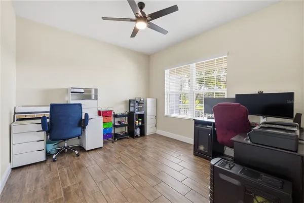 a view of a workspace with furniture and a window