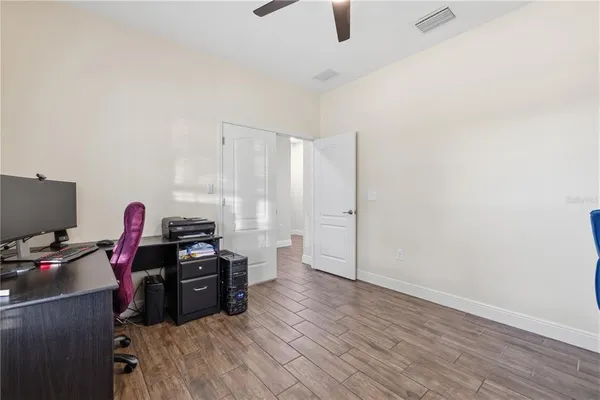 a view of a workspace with furniture and a window