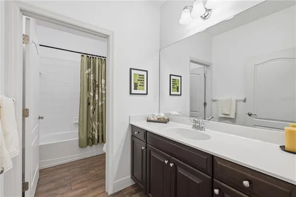 a bathroom with a sink a mirror and a shower