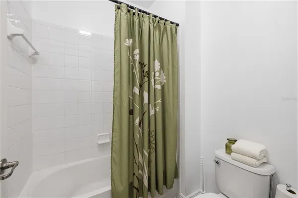 a bathroom with a shower and a toilet