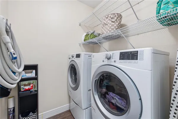 a close view of a utility room with dryer and washer