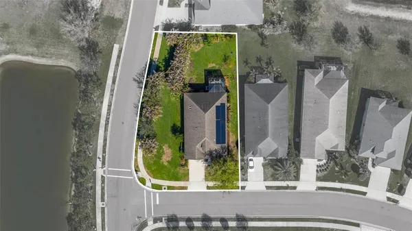 an aerial view of residential house with outdoor space and swimming pool