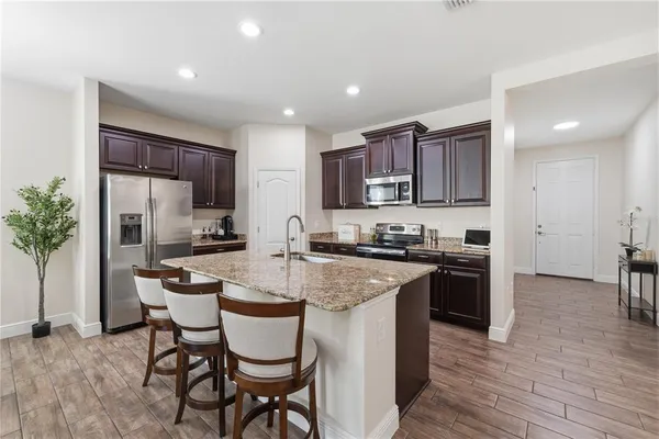 a kitchen with a sink stove and microwave