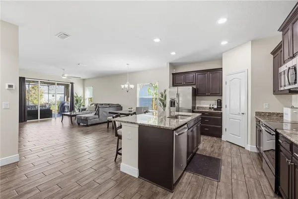 a kitchen with counter top space a sink appliances and cabinets