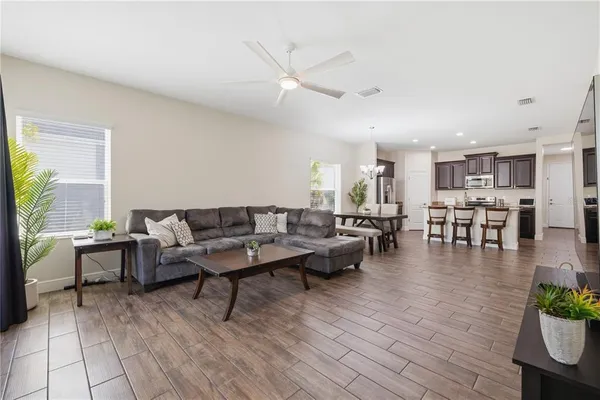 a living room with furniture and wooden floor