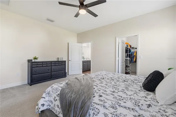 a bedroom with a bed and a dresser