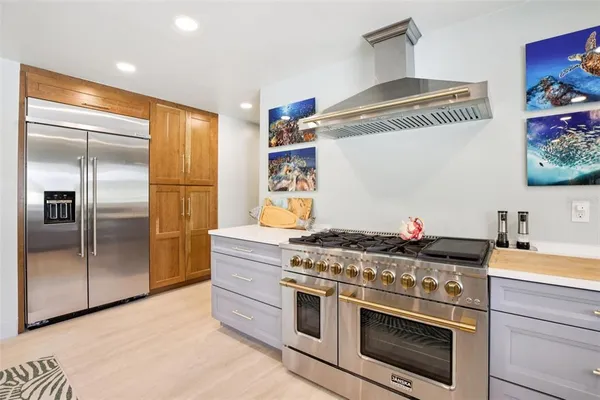a kitchen with stainless steel appliances granite countertop a stove and a refrigerator
