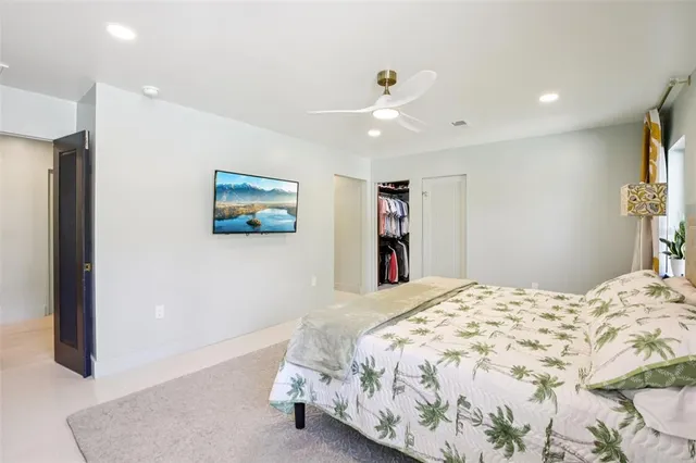 a bedroom with a large bed and a couch