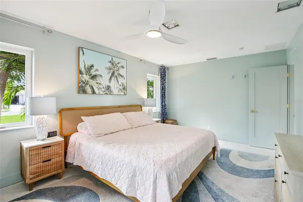 a bedroom with a bed and a painting on the wall