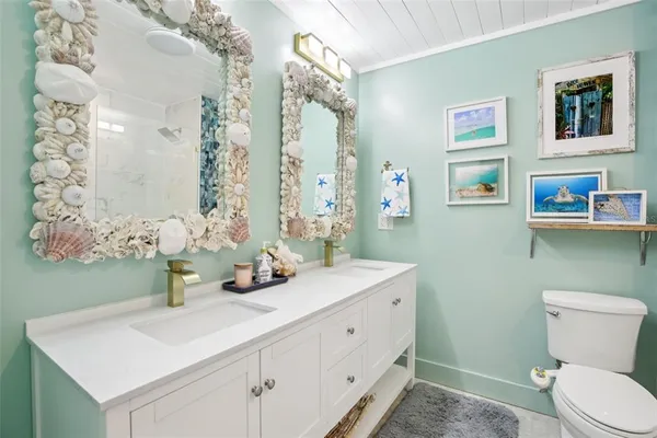 a bathroom with a sink a toilet and shower curtain