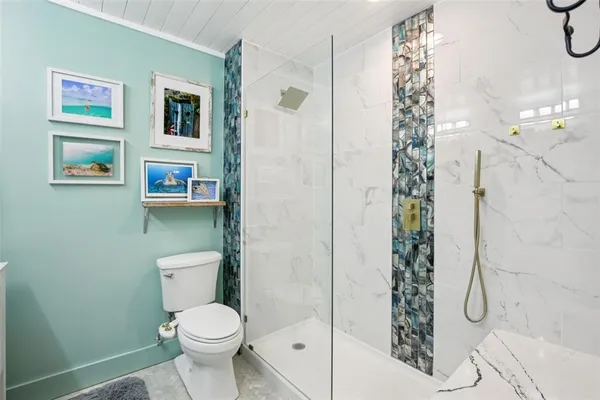 a white toilet sitting next to a bathroom sink