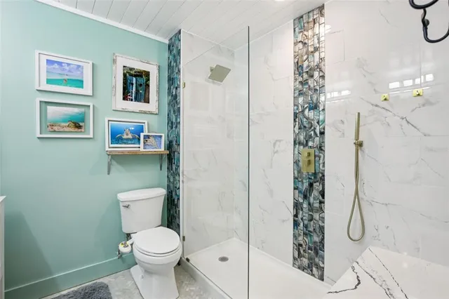 a white toilet sitting next to a bathroom sink