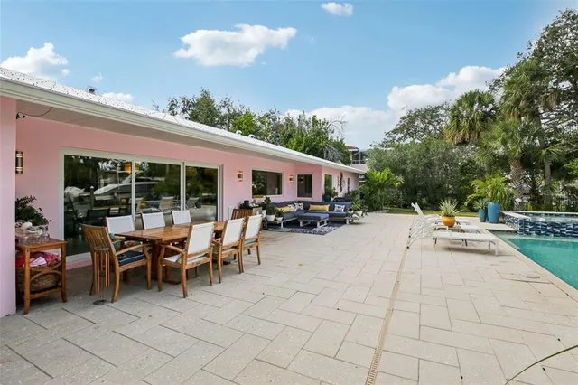 a view of a patio with dining table and chairs with wooden fence