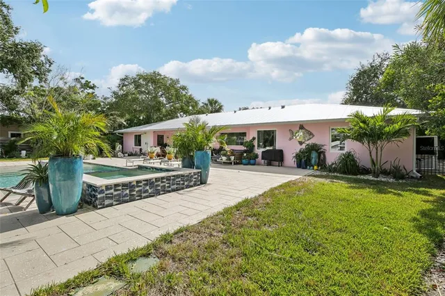 a view of a swimming pool with outdoor seating and a garden