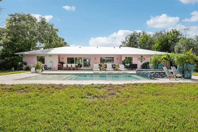 a view of house with garden and tall trees