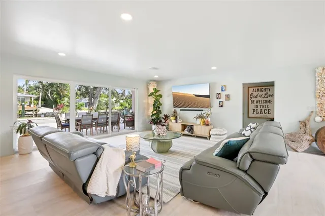 a living room with fireplace furniture and a large window