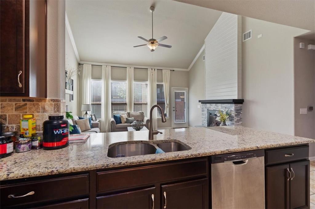 12311 Altamira Street Austin, TX 78748 - Photo 11 of 36 a kitchen with sink a window and cabinets