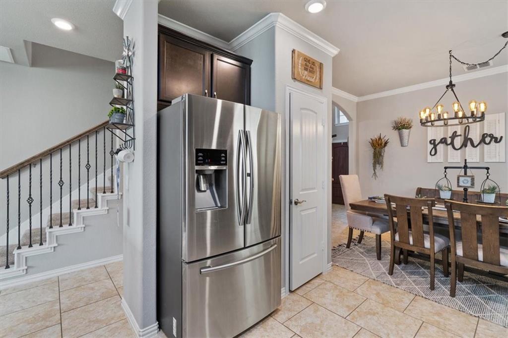 12311 Altamira Street Austin, TX 78748 - Photo 12 of 36 a kitchen with stainless steel appliances granite countertop a refrigerator and a dining table