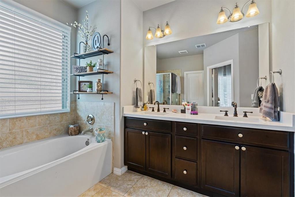 12311 Altamira Street Austin, TX 78748 - Photo 15 of 36 a bathroom with a tub sink double vanity granite and tub
