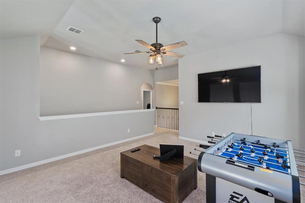 12311 Altamira Street Austin, TX 78748 - Photo 22 of 36 a living room with furniture and a flat screen tv