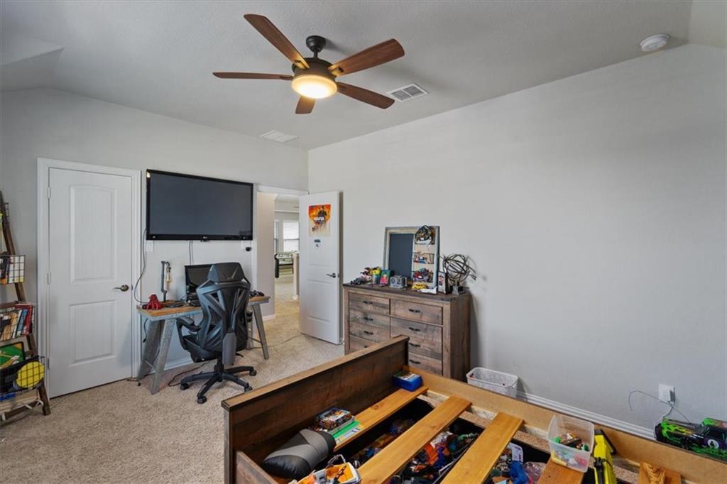 12311 Altamira Street Austin, TX 78748 - Photo 26 of 36 a view of a workspace with furniture and a flat screen tv