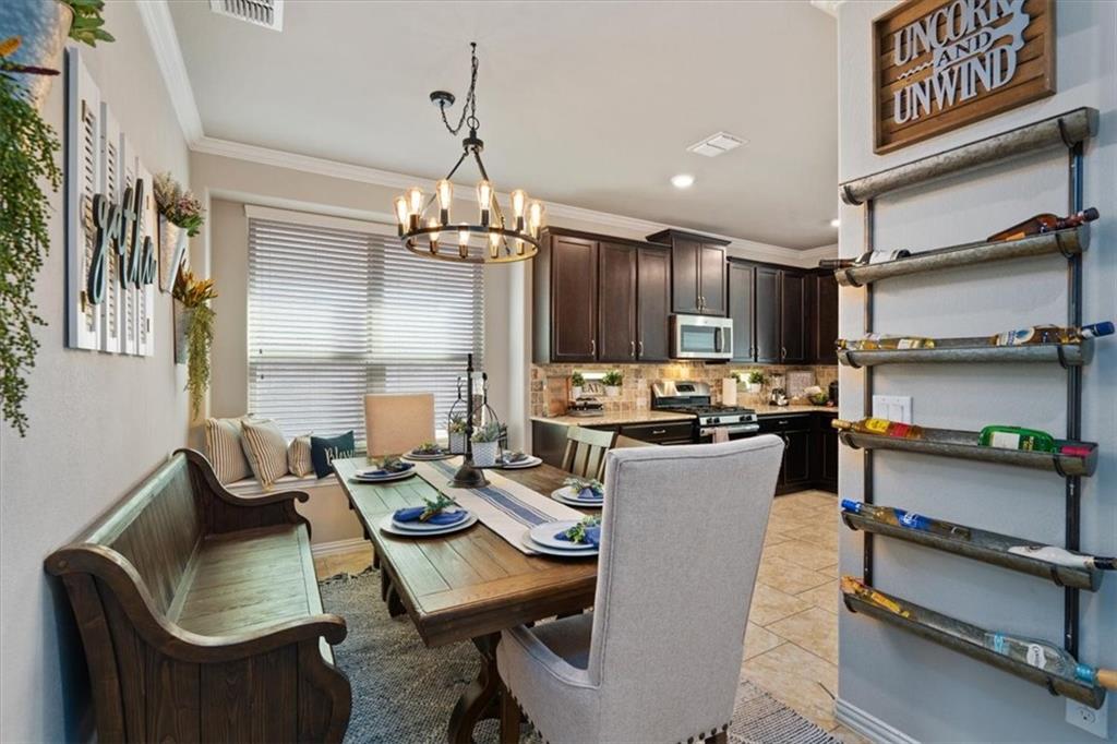12311 Altamira Street Austin, TX 78748 - Photo 9 of 36 a kitchen with a dining table chairs sink and stove