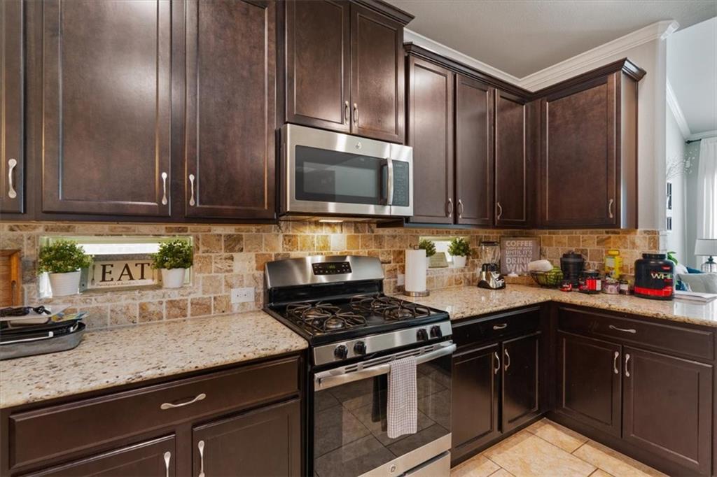 12311 Altamira Street Austin, TX 78748 - Photo 10 of 36 a kitchen with granite countertop cabinets stainless steel appliances and a counter space