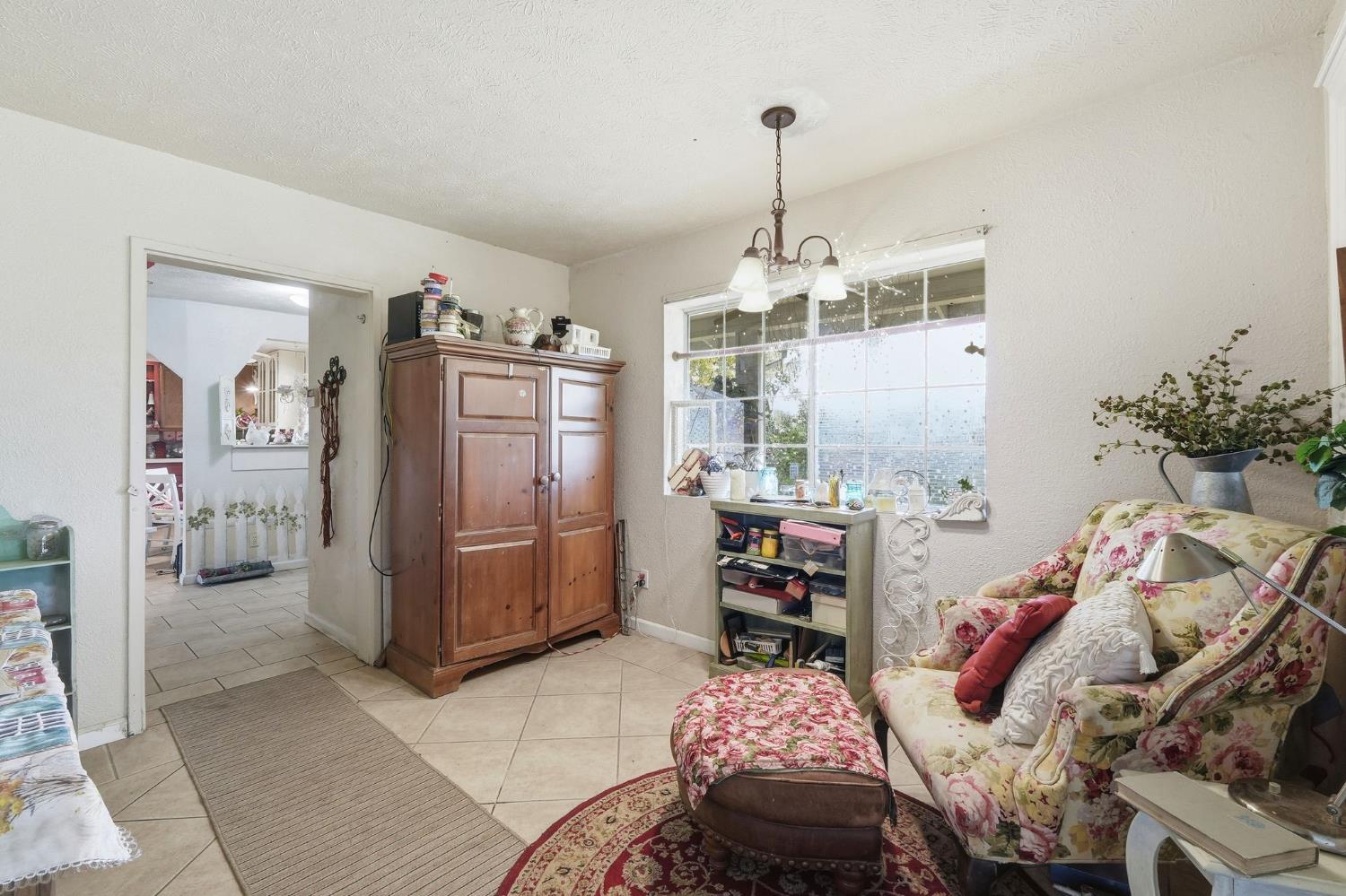7801 El Modena Avenue Elverta, CA 95626 - Photo 11 of 51 a bedroom with furniture and a chandelier