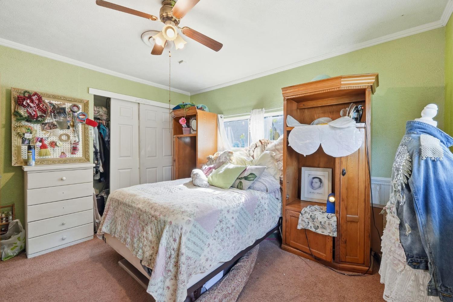7801 El Modena Avenue Elverta, CA 95626 - Photo 22 of 51 a bedroom with a bed a dresser and painting on the wall