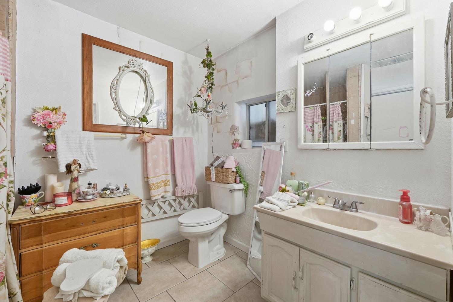 7801 El Modena Avenue Elverta, CA 95626 - Photo 28 of 51 a bathroom with a granite countertop sink mirror and toilet