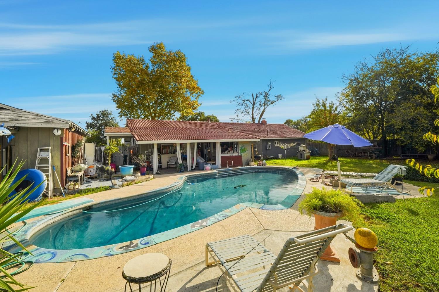 7801 El Modena Avenue Elverta, CA 95626 - Photo 35 of 51 a view of a house with pool and chairs