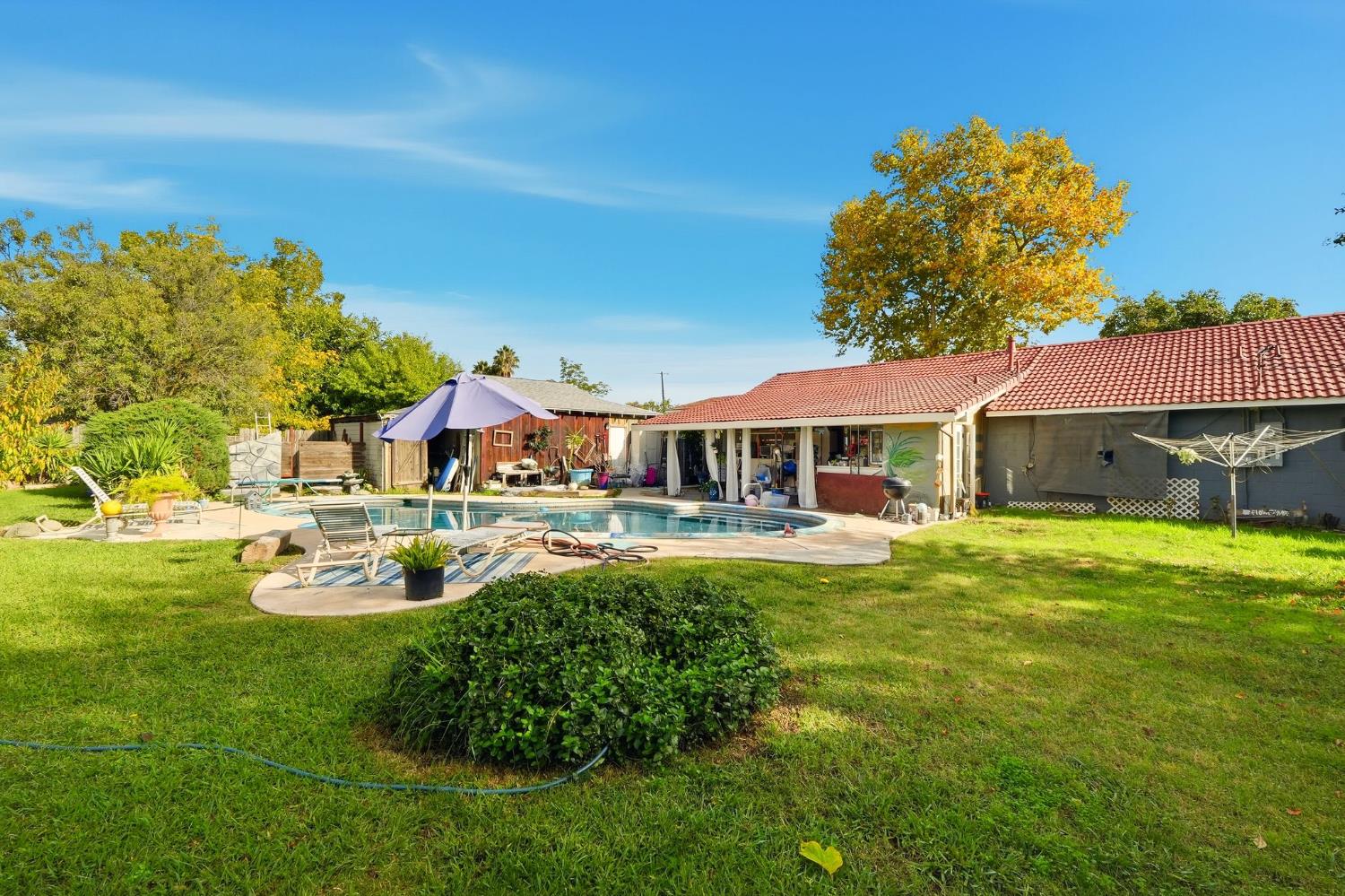 7801 El Modena Avenue Elverta, CA 95626 - Photo 39 of 51 a front view of a house with swimming pool having outdoor seating