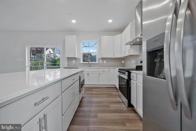 a stove top oven sitting inside of a kitchen